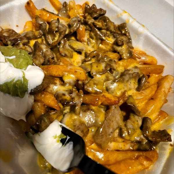 Manuel's El Burrito's carne asada fries with melted cheese, guacamole, and sour cream.
