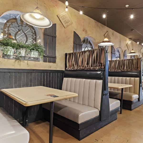 Interior of Manuel's El Burrito Restaurant with booths, tables, and Mexican-inspired decor.